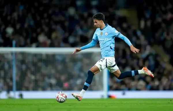 Vitor Reis preparing to enter the pitch for Manchester City in the Premier League
